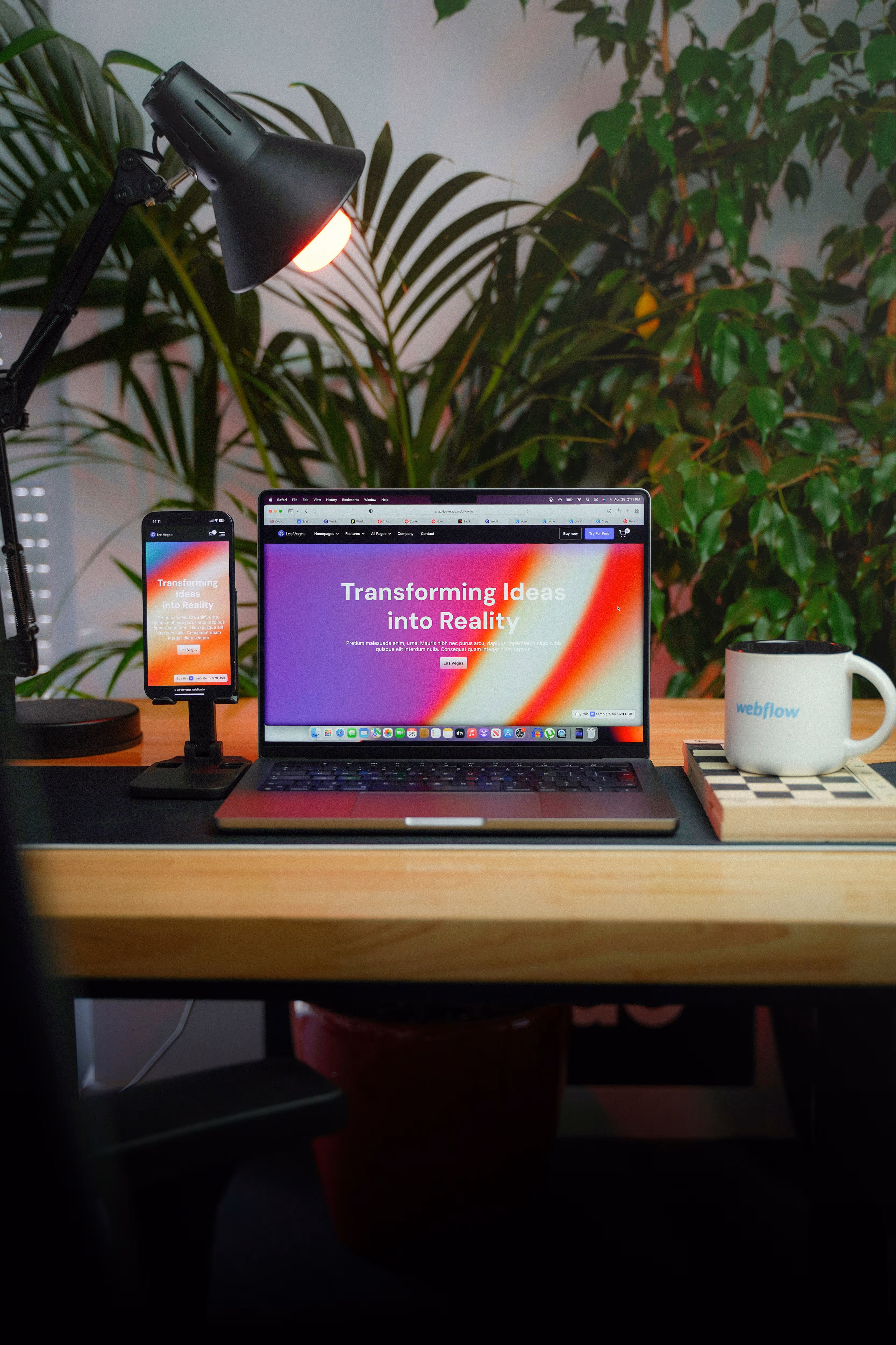 Laptop next to a chessboard with website mockups