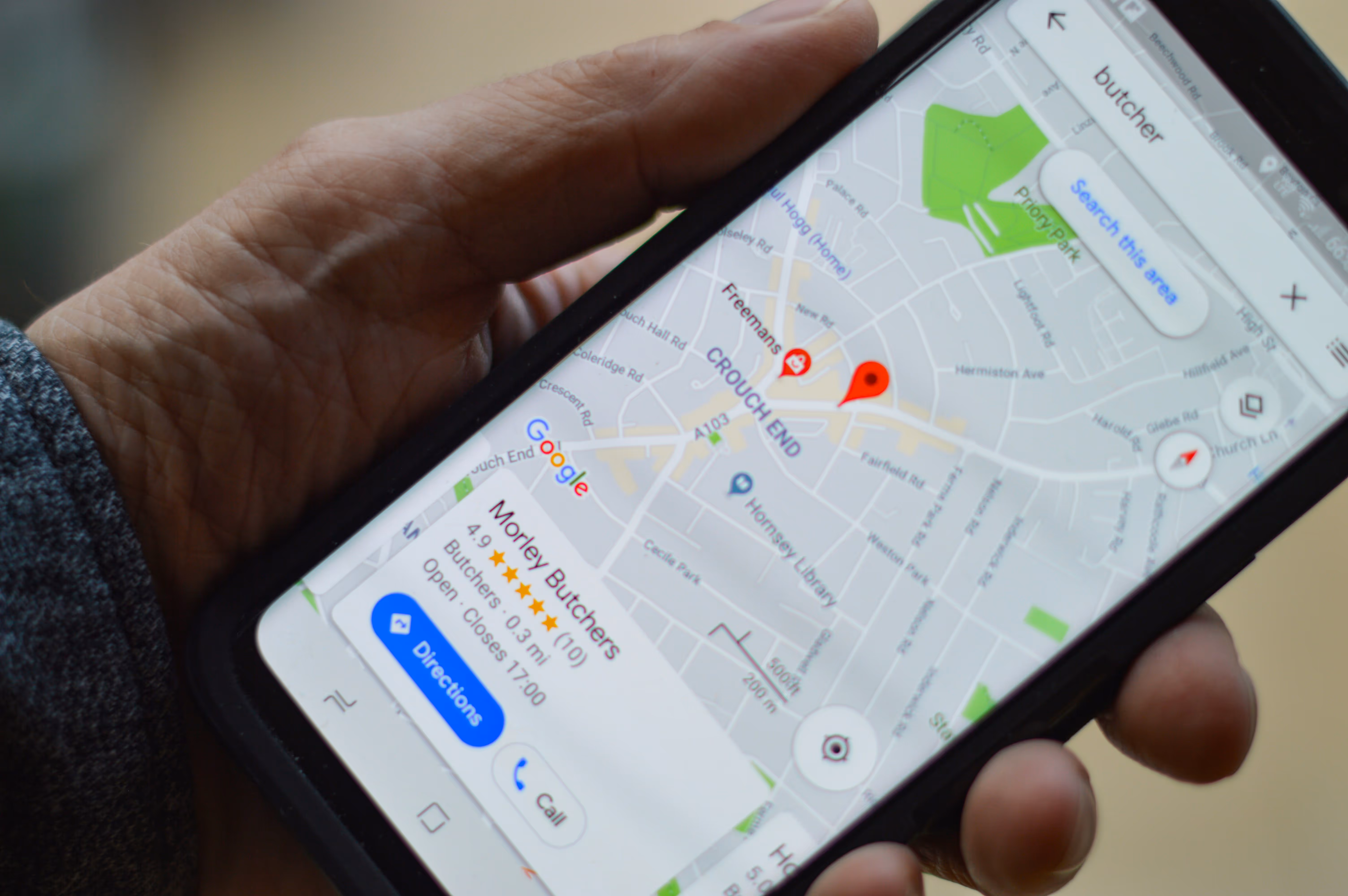 Phone with a local business pinpointed on Google Maps
